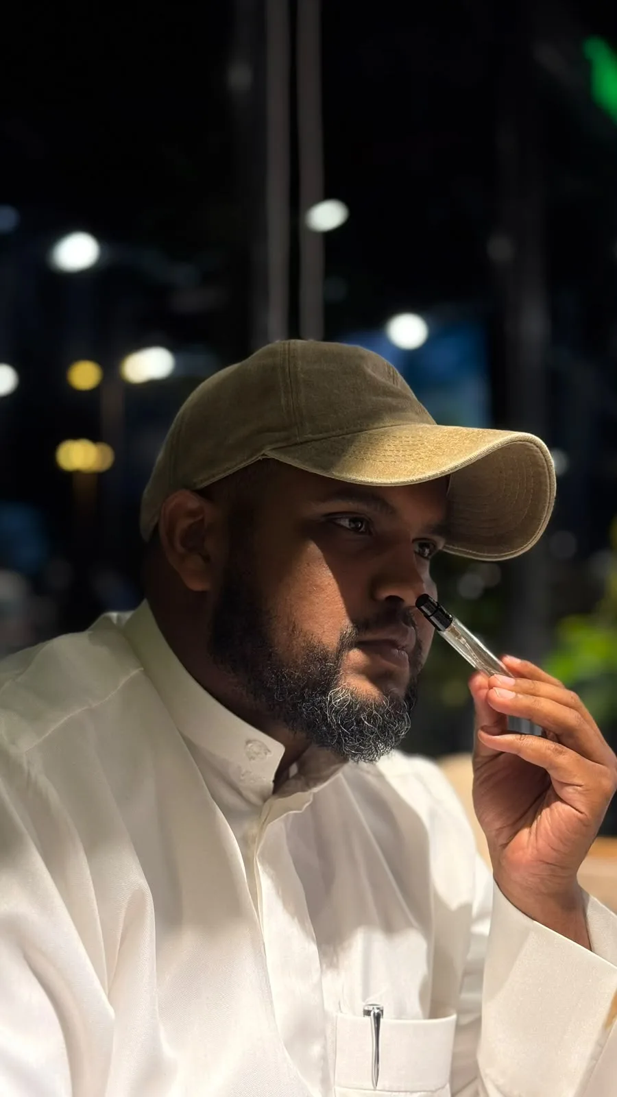 Mohamed Abdo smelling a perfume blotter