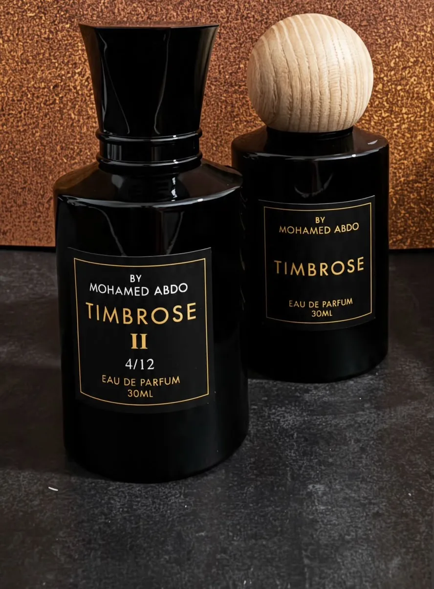 Timbrose II and Timbrose side by side: two black bottles with gold labels, one with a flared black cap and one with a round wooden cap